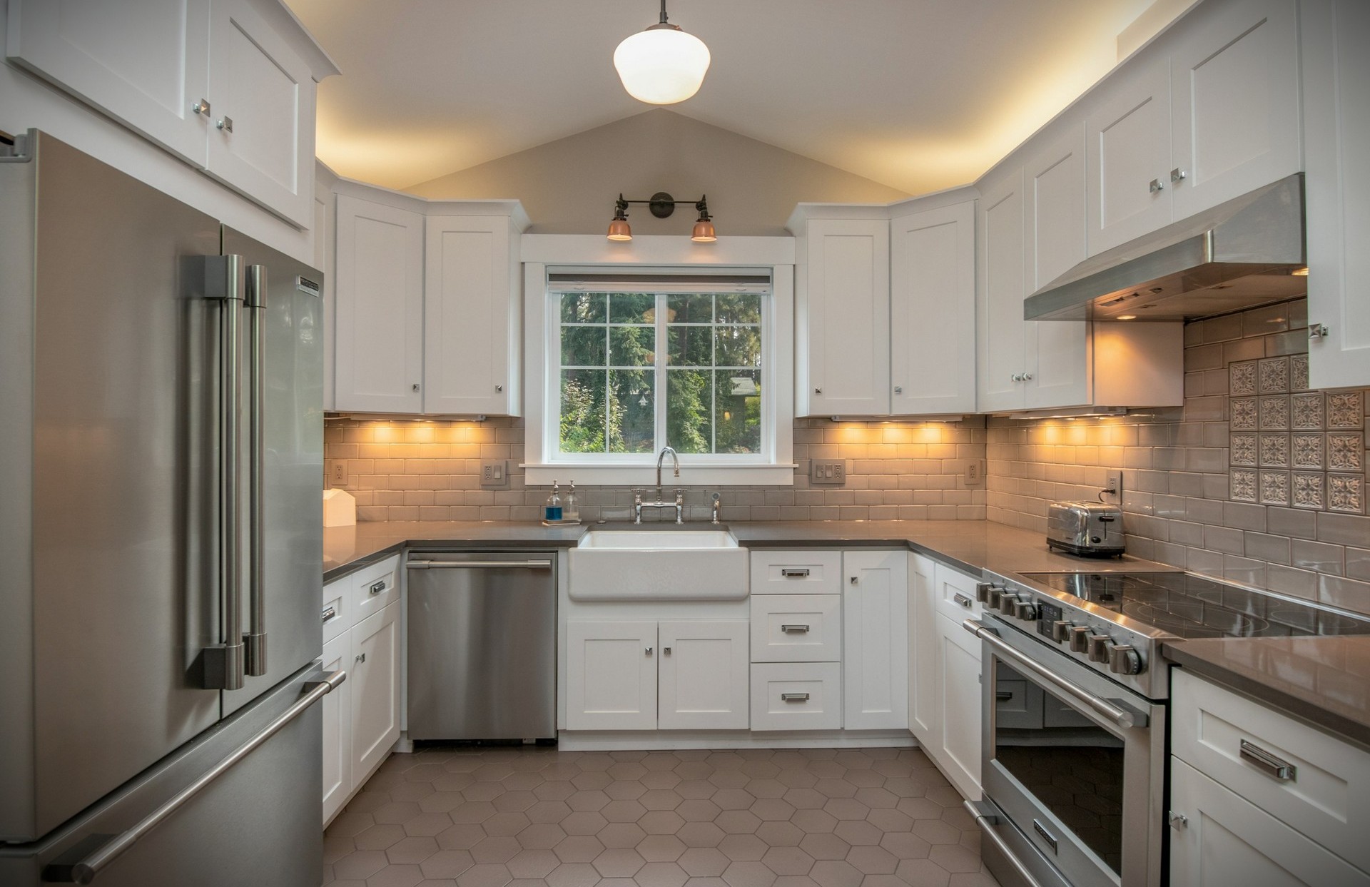 White kitchen cabinets with stainless steel appliances